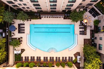 A swimming pool surrounded by lounge chairs